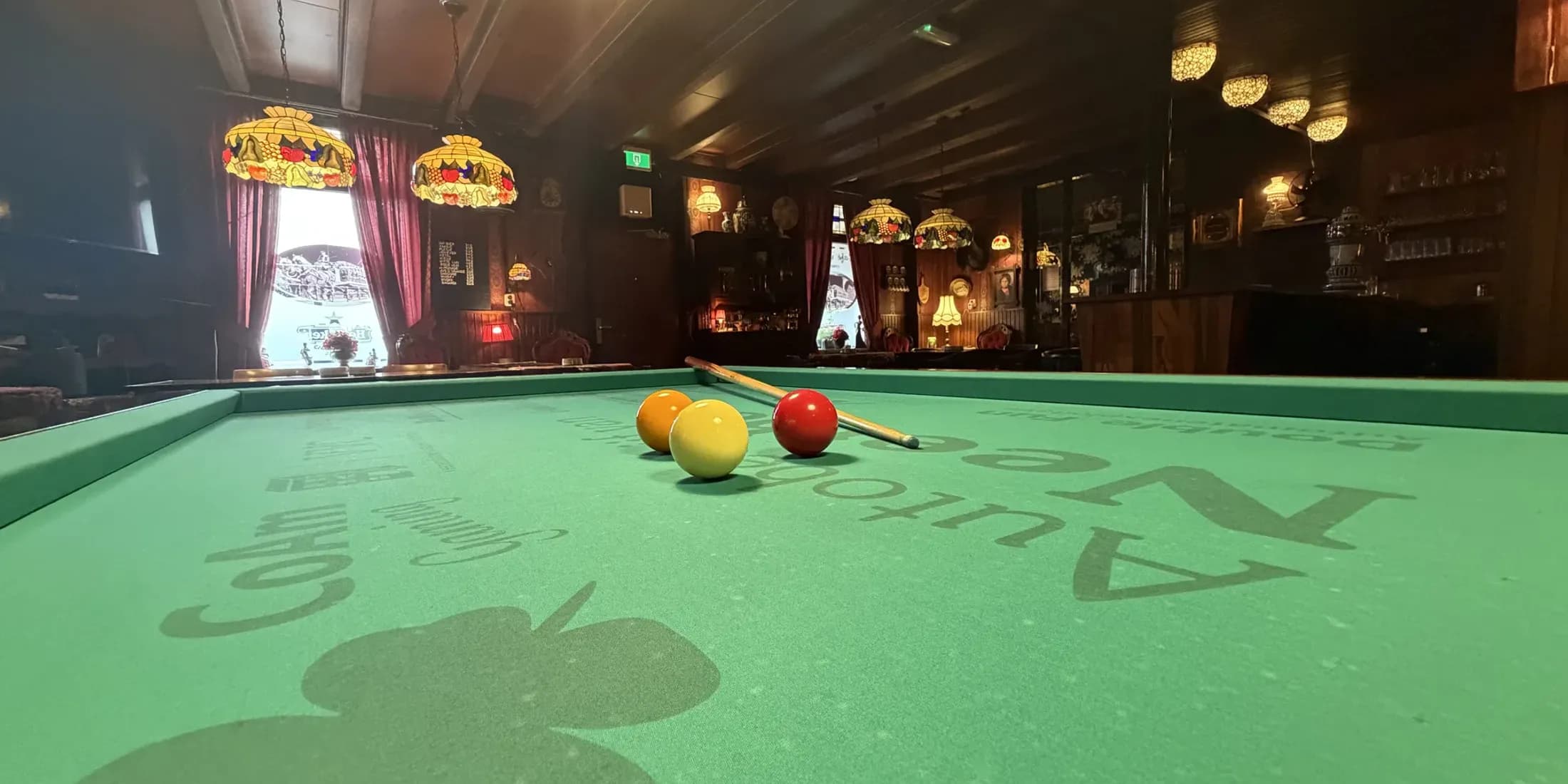 Biljartballen en keu op het groene laken